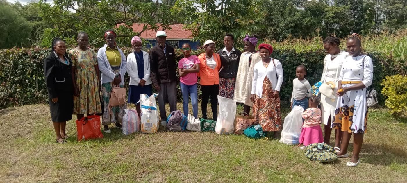 Families gathered with their food parcels after a distribution