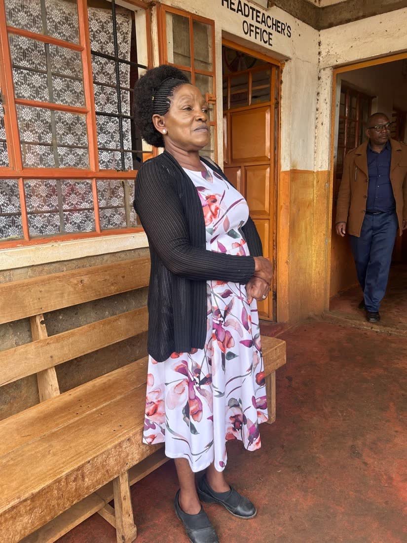 Dr. Naomi Karaya standing outside the headteacher's office at the school